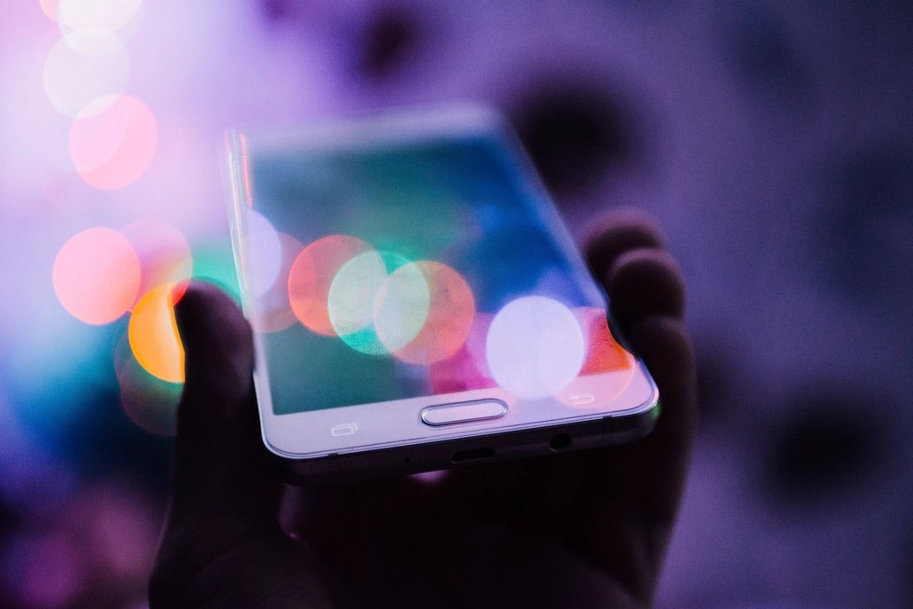 Smartphone displaying a Shopify store product page alongside a mobile speed score gauge showing a low performance result